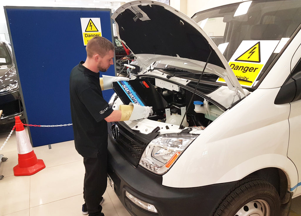 Electric vehicle next to a conventional internal combustion engine car